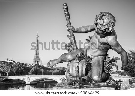 Black and White Paris: Sculpture of Child on the bridge of Alexander III in the morning, with the Eiffel Tower in the background
