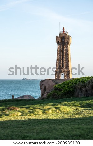 Lighthouse at sunrise on the Pink Granite Coast in Brittany in the northwest part of France.