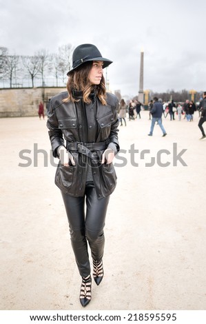 PARIS - MARCH 1, 2014: Stylish European woman with leather jacket and trousers in the Tuileries Garden.  Paris is one of the capitals of fashion in the world.
