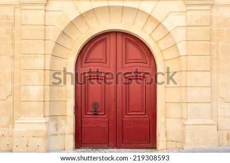 Red old wooden door in Paris, France