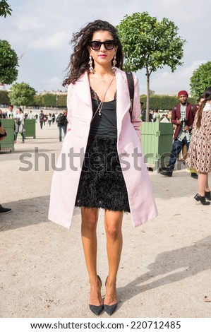 PARIS - SEPTEMBER 30, 2014: Stylish european woman with pink trench coat in the Tuileries Garden. Paris Fashion Week: Ready to Wear 2014/2015 is held from September 23 to October 1, 2014.