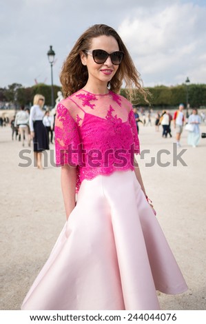 PARIS - SEPTEMBER 30, 2014: Stylish european woman with pink dress in the Tuileries Garden. Paris Fashion Week: Ready to Wear 2014/2015 is held from September 23 to October 1, 2014.