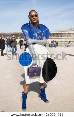 PARIS, FRANCE - MARCH 6, 2015: Stylish Black woman with dress like astronaut\'s. Paris Fashion Week: Ready to Wear 2015/2016 is held from March 3 to 11, 2015.