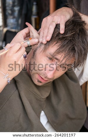 PROVINS, FRANCE - JUNE 15, 2014: Someone put a elf\'s ear on a man\'s head. The medieval festival is held annually in a weekend of June.