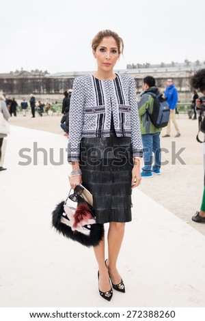 PARIS, FRANCE - MARCH 10, 2015: Stylish European woman with black leather skirt in the Tuileries Garden. Paris Fashion Week: Ready to Wear 2015/2016 is held from March 3 to 11, 2015.