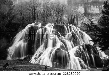 Waterfall of Tufs near the Jura mountain French village of Baume-Les-Messieurs , Franche Comte, France