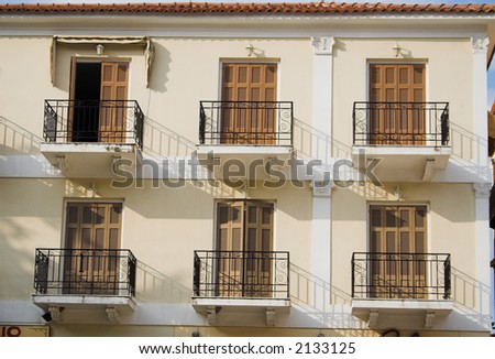Six balconies under a terracotta roof