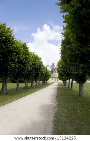 Chateau Chambord in France at the end of a tree-lined avenue