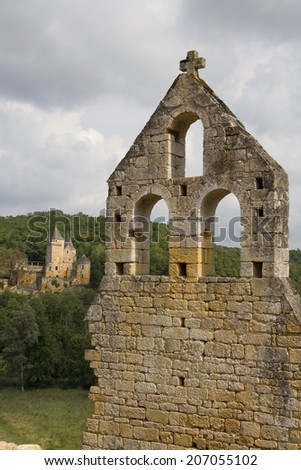 View of a French castle across the valley with a ruined church in the foreground