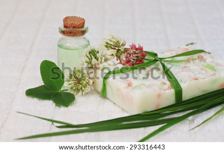 Handmade soap bar aromatherapy oils herbal cosmetics scented clover flower fresh green leaves, relaxing bathroom care set