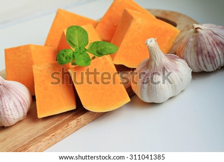 fresh garden vegetables pumpkin garlic onions basil herb healthy homegrown products wooden kitchen board empty space