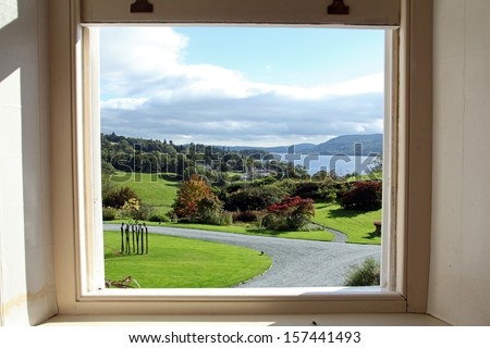 a picture window view of Lake Windermere in Lake District, UK