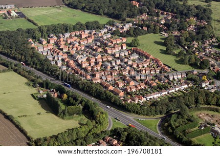 aerial view of houses on UK housing estates, some with solar roof panels