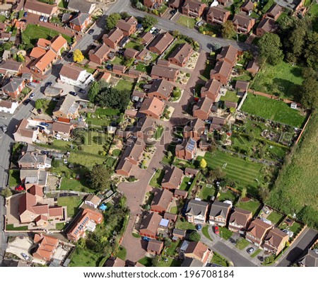aerial view of houses on UK housing estates, some with solar roof panels