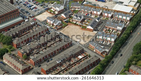 aerial view of new and old housing including back to back terrace houses in Oldham, UK