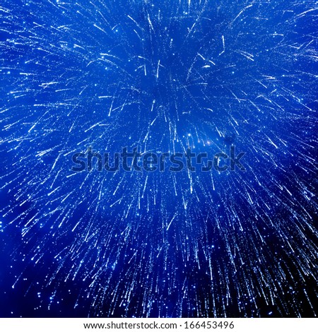 blue fireworks against night background for new year celebration
