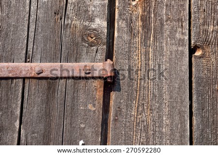 Old door hinge on wooden door