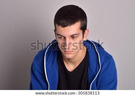 thinker attractive young man in a blue hoodie
