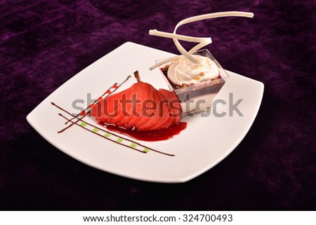 Plated dessert with poached pears in white porcelain plate