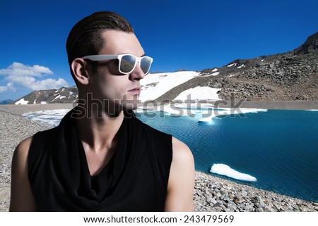 Portrait of a young handsome man, wearing tinted sunglasses