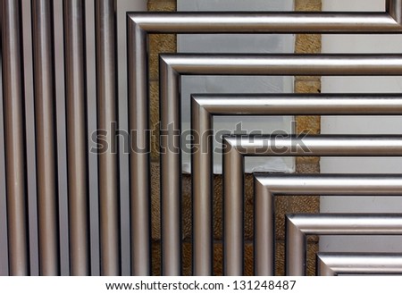 A stainless steel tubes against the wall