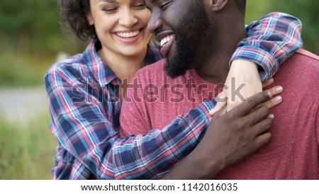 Similar – Image, Stock Photo Delicate multiethnic couple hugging under natural arch of flowers