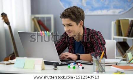 Similar – Image, Stock Photo Student learning at home. Young woman making notes, reading and learning from notepad