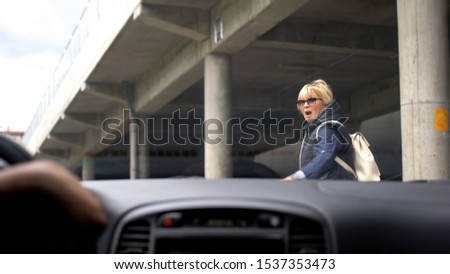 Inexperienced automobilist driving car city, scared woman running away, danger Imagine de stoc © 
