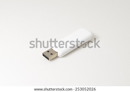 White USB Pendrive. Shoot over white background. Shallow depth of field. Focus on the USB connector.