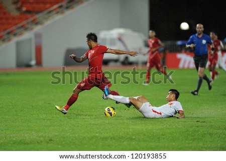 BANGKOK,THAILAND-NOVEMBER 24:Kyi Lin of Myanmar (r) in action during the AFF SUZUKI CUP 2012 between Vietnam and Myanmar at Rajamangkala stadium on Nov 24,2012 inThailand.