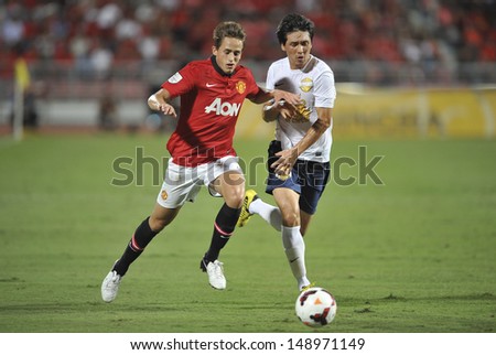BANGKOK,THAILAND-JULY13: Adnan Januzaj(L) of Manchester United in action during the friendly match between Singha All Star and Manchester United at Rajamangala Stadium on July 13, 2013 in Thailand.