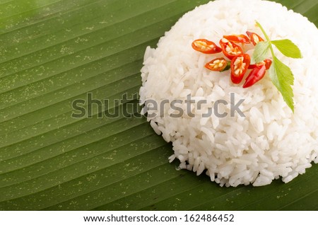 Cooked rice with chillies & coriander leaves on banana leaf