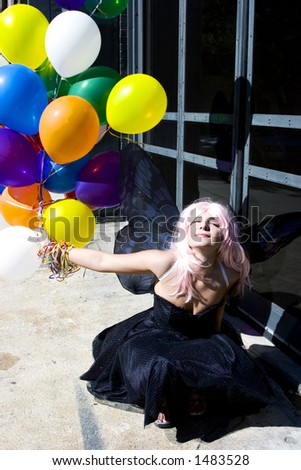 Fairy with balloons enjoying the sun
