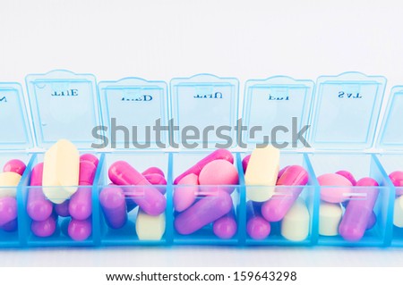 Tablet and capsule in daily pill box show medicine concept