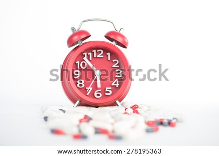 Red clock and capsule show health care and medicine time concept