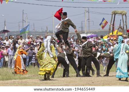 SMALL CHAPURNIKI, VOLGOGRAD, RUSSIA - MAY 24:Dancing group in folk costumes and the form of the Soviet army at the festival Sabantui-2014 . May 24, 2014 in Volgograd, Russia.