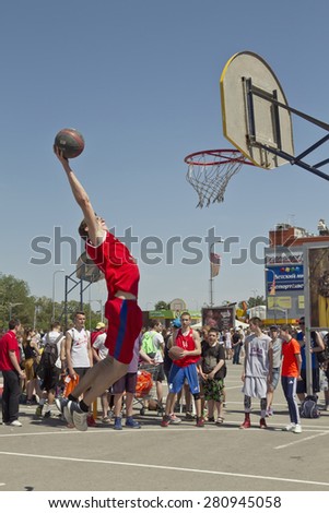 VOLGOGRAD, RUSSIA - MAY 24: A young basketball player performs a throw to the slam dunk contest. Annual streetball party organized Europa city Mall, on May 24, 2015 in Volgograd, Russia.