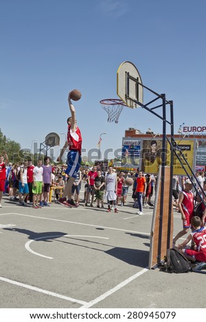 VOLGOGRAD, RUSSIA - MAY 24: A young basketball player performs a throw to the slam dunk contest. Annual streetball party organized Europa city Mall, on May 24, 2015 in Volgograd, Russia.