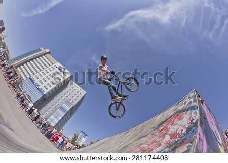 VOLGOGRAD - MAY 24: The BMX cyclist performs a stunt jump during the annual sport event organized by Europa city Mall on May 24, 2015 in Volgograd, Russia.