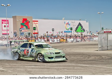VOLGOGRAD - JUNE 6: Drift car team X-Round enters the bend with slip during demonstrations as part of the tour on cities of Russia \