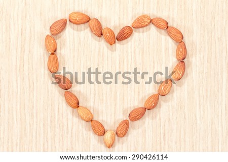 Almonds are laid out in the shape of a heart on the dining table