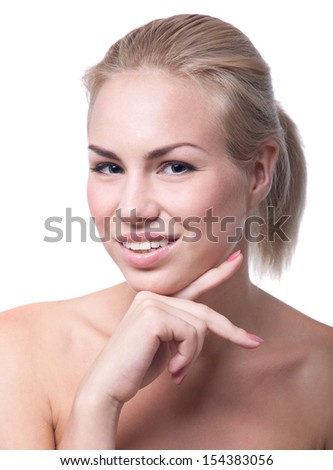 Portrait of beautiful blond woman with clean face, hair pulled back, holding her hand near her chin. Over white background