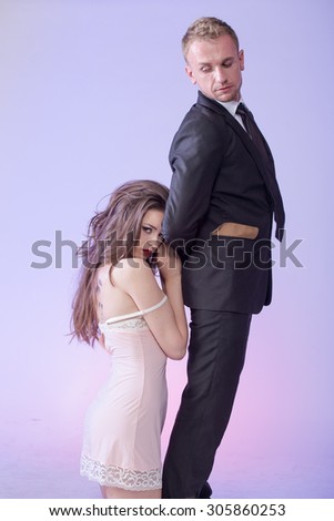 Passionate photo of the girl together with a guy. Studio photography. Attraction.