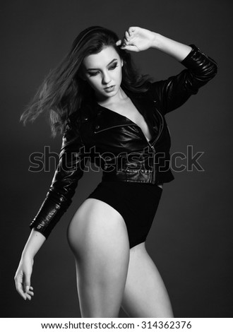 black and white photo sexy girls brunettes in erotic clothing on a black background
