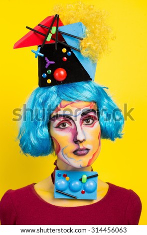 Studio art photo girls c blue hair and art makeup and positive emotions on a yellow background
