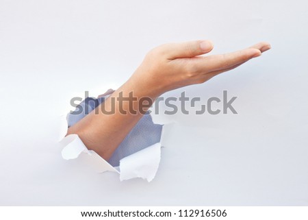 Empty open hand breaking through the hole in white background