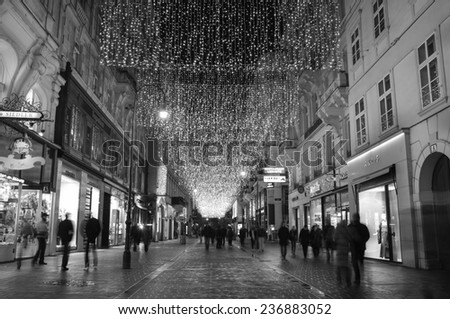 VIENNA, AUSTRIA - December 11, 2009: Vienna -  street at night with tourists and Christmas chandeliers in Vienna, Austria. on December 11, 2009.