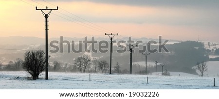 Electric line on the snow-covered hill, in winter.
