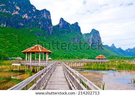 Wooden pavilion and wooden bridge in lotus lake, Samroiyod national park, thailand