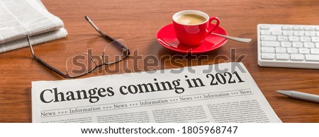 A newspaper on a wooden desk - Changes coming in 2021 Photo stock © 